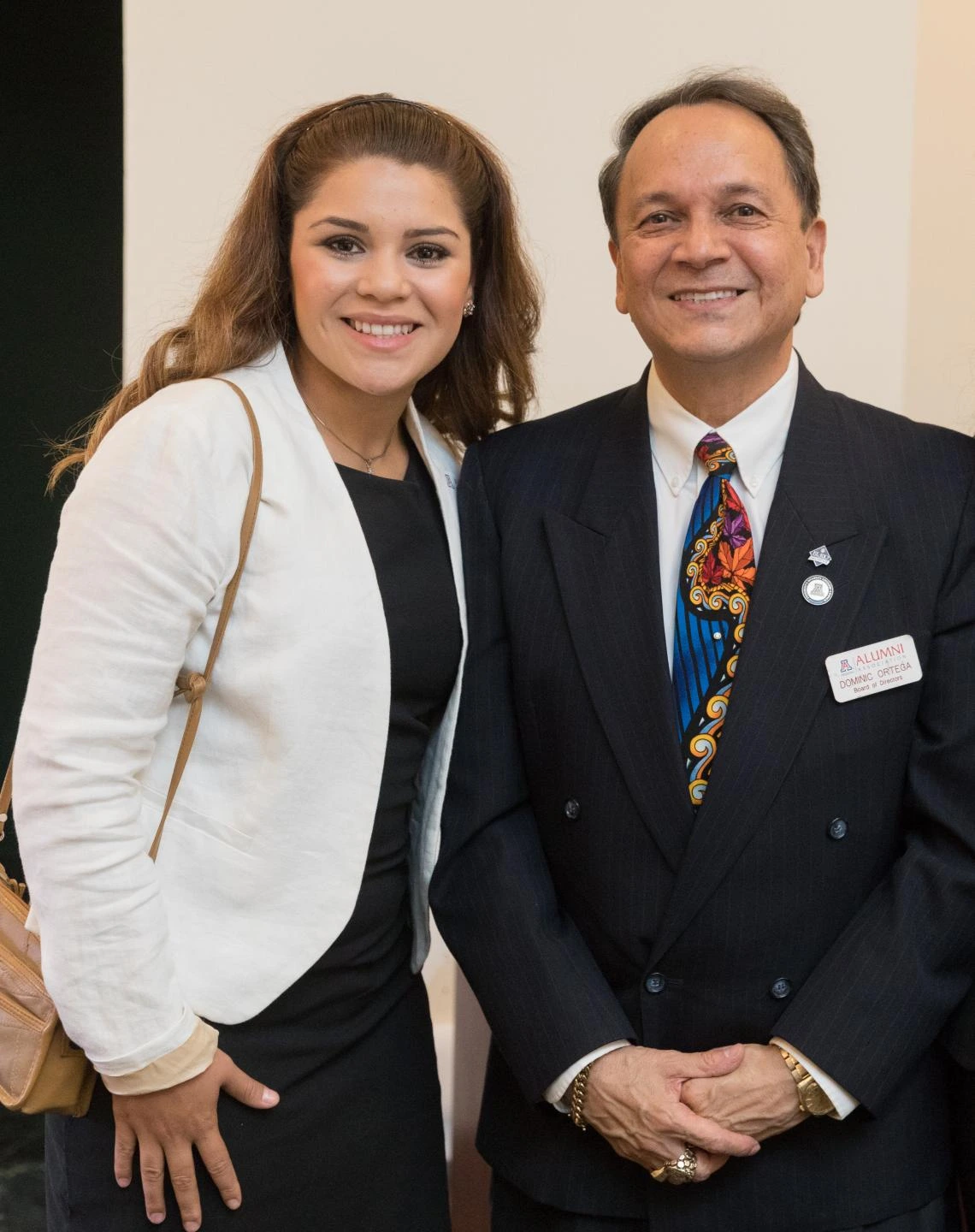 Two students recognized and awarded at the annual Celebration of Excellence event take a photo with a community leader, all are facing the camera